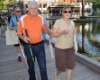 Two people walking on a pier