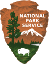 National Parks Service Sign with a tree, mountain, and bison